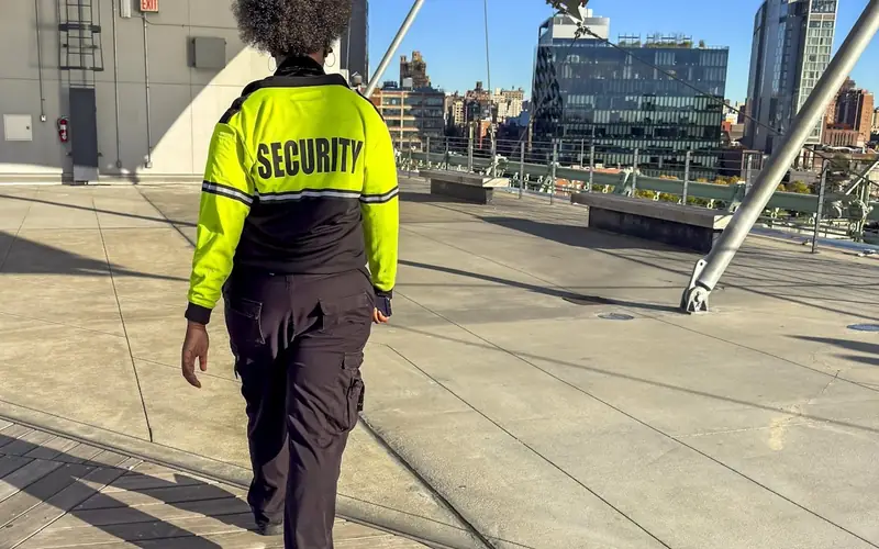 Security officer on patrol in high-visibility uniform